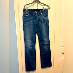 WHBM boot cut jeans size 4 medium wash with a rhinestone detail